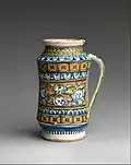 Fashioned with one handle and decorated with multiple cherubs as seen through the middle of the jars exterior. Manufactured between 1510 and 1530. Located at the Metropolitan Museum of Art in the European Sculpture and Decorative Arts collection.