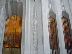A series of tall windows at 1 Wall Street. Between each window are limestone piers.