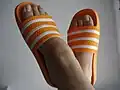 Woman wearing orange slides