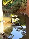 The creek flowing beneath a footbridge at Canley Vale