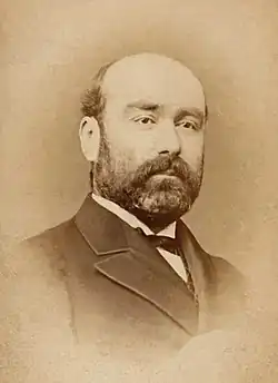 Portrait of a bald and bearded man.