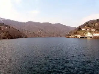 A body of water with mountains in the distance.