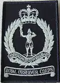 1986 pattern badge, worn on the right breast of green coveralls; both of which were issued only to Post personnel.