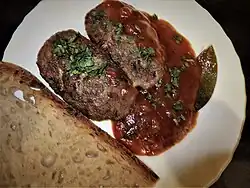 Pârjoale with sauce and bread.