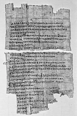 Black and white photograph of a fragment of papyrus with Greek text