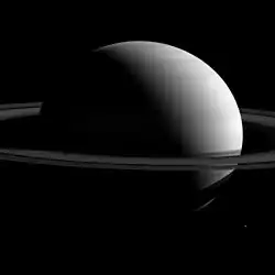 Tethys (lower right) near Saturn and its rings