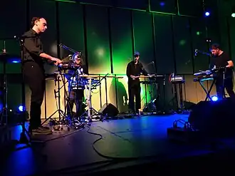 The group playing live in Liverpool in 2021; from left to right: Hering, Fair, Hunt, Duvall