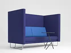 A sofa with high arms/seat back for meetings and or extra privacy in public spaces, designed by Busk-Hertzog in 2011.