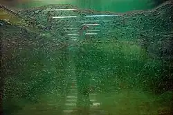 A green-colored mural depicting a hill made with fiberglass.