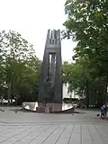 Monument to Vincas Kudirka in Vilnius is topped by Columns of Gediminas.