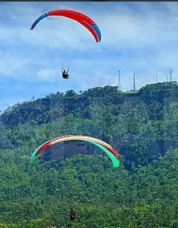 photo of a paraglider in front of a mountain