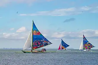 Painted paraws sailing across the Iloilo Strait