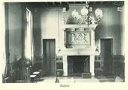 Photograph of the lycée's parlor at the end of the 19th century, showing a large carved fireplace.