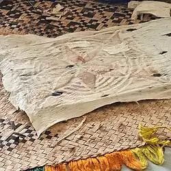 Holes in the rubbed fabric are patched before another layer is placed on top