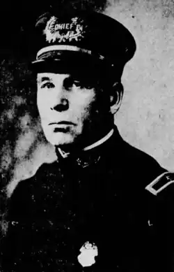 Black-and-white photograph of a man wearing police uniform