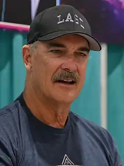 Warburton wearing a black cap