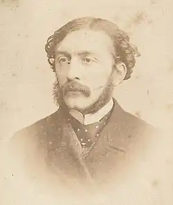 Portrait of Paul de Rémusat, French journalist and politician, wearing a dark coat and tie, with a mustache and beard.
