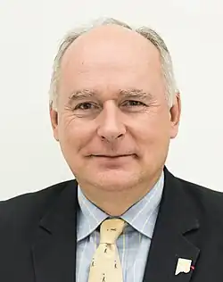Professional headshot of Paweł Zalewski in a suit.