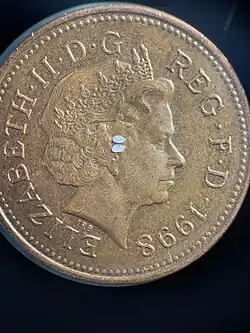 Sagittal otoliths compared to a 1998 British penny