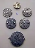 Openwork silver disk brooches