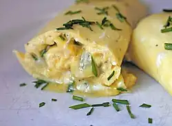Bright yellow omelette garnished with chives