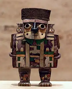 Mosaic figurine of a noble man (Wari); 7th-9th century; wood, shell, stone and silver; height: 10.2&nbsp;cm; Kimbell Art Museum (Fort Worth, Texas, US)[80]