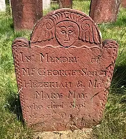 A marker dated 1775 carved by Peter Buckland of Manchester, made of brick red brownstone from the Buckland Quarry in Manchester