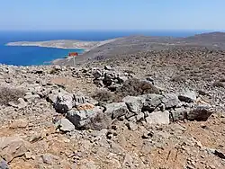 A three-sided stone room, in ruins, on a mountain-top