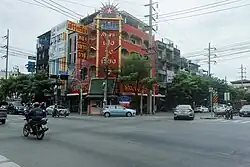 Phran Nok Intersection as seen from Itsaraphap Road in 2018. Ban Chang Lo lies to the left, in the direction the two cars are turning, while Siriraj is on the right