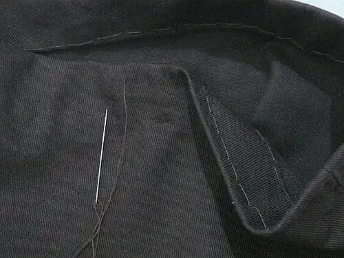 A pick stitch hem made with thread that matches the fabric, to appear invisible on the outside of the garment