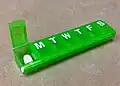 Pill box with hinged lids to compartments