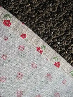 A plain hem, folded once and sewn with a running stitch