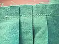 Knife pleats with the construction and seam stitches shown.
