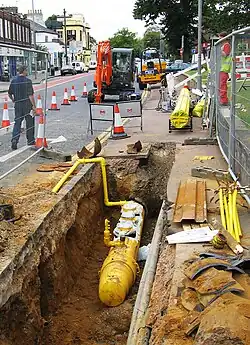 Image 17Polyethylene plastic main being placed in a trench (from Natural gas)