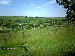 Small village behind lots of grass
