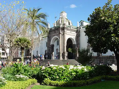 The northeast elevation of the cathedral, on the Plaza, is dominated by the "Arch of Carondelet" entrance (built in 1797) and its staircase.