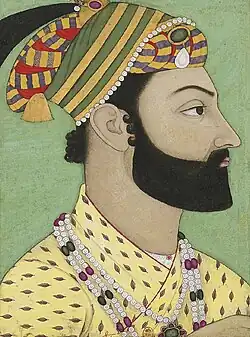 A color portrait of a bearded man wearing a turban