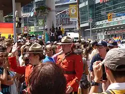 two men in red uniforms amidst a crowd of people