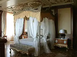 One of the bedrooms in the residence with a canopy bed