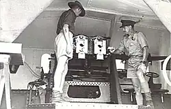 Officers inspect breeches of twin 6pdr gun. 1943.[gallery 18]