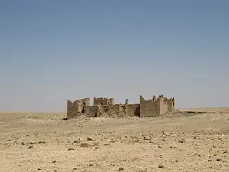 Fortress standing alone in an arid landscape