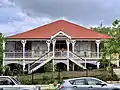Kameruka, Ipswich (1917). Federation Filigree style Queenslander with double access stairs.[74][75]