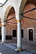 A round column (mid) and a polygonal column (left) of the courtyard's colonnad