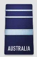 A black shoulder board with the word "AUSTRALIA" across the bottom. Above the word is a thick, blue horizontal stripe, with two thinner blue horizontal stripes above that.