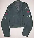 No.2 Battledress blouse, (RAF 1947 pattern), showing medal ribbon bar and plastic Beacon Lighter buttons. Sleeves: Shoulder flash, Group numeral, Red "Spitfire" proficiency and Leading Observer badges.
