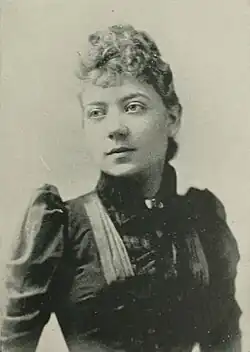 19th-century B&W portrait photo of a woman with her hair in an up-do, wearing a dark, fitted blouse.