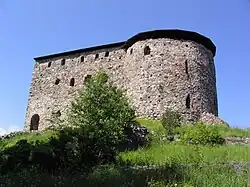 The remains of Raseborg Castle, a large brick building.