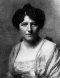 A white woman with dark hair in an updo