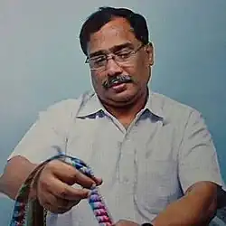 Rajagopal holding a 35mm film reel