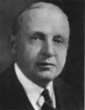 Old picture of an older executive man dressed in a suit and tie